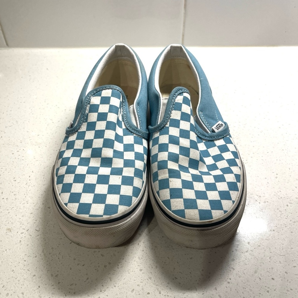 Blue and white checkered slip on vans. Used but in good condition.